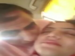 Pakistani couple romance and caressing in car